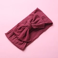 Detail view of burgundy soft nylon headband featuring a large double-layered bow knot - Burgundy
