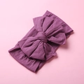 Detail view of burgundy soft nylon baby headband with layered oversized bow and ribbed texture - Light Purple