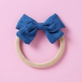 Detail of baby headband featuring navy jacquard bow and soft beige elastic nylon strap - Blue
