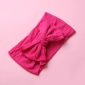 Close-up of rose red nylon bow headband with soft knitted texture for baby girls - Rose Red