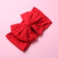 Detail of soft nylon red bow headband showing textured fabric and handmade knot - Red
