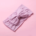 Detail of soft nylon baby headband showing double-layered large bow on pink background - Taro Purple