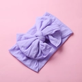 Macro shot of soft lavender nylon headband featuring a large double-layered bow for babies - Purple