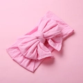 Detailed texture of pink soft nylon baby headband with a large swallowtail bow design - Pink