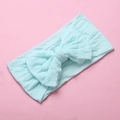 Detail of soft mint green nylon baby headband with a large knotted decorative bow - Sky Blue