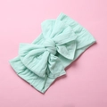 Detail of mint green soft nylon baby headband with a large layered knot bow - Mint Green