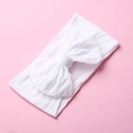 Detailed texture of white soft nylon bow headband for baby girls on pink background - White