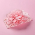 Detail of pink nylon baby headband featuring a large multi-layered 3D fabric flower - Pink