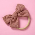 Detail of baby headband featuring dusty pink cotton bow with floral embroidery - Khaki
