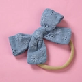 Detailed macro view of the blue cotton embroidered bow on a soft nylon baby headband - Sky Blue