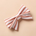Detailed macro view of children's floral hair clip featuring orange striped fabric texture - Orange White Striped Style (3)