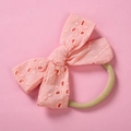 Detail view of pink cotton embroidered lace bow with soft nylon headband for infants - Light Orange