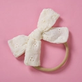 Detail showing white lace embroidery bow with high elastic soft nylon headband for babies - Beige