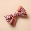 Detailed fabric texture of baby hair clip with orange floral daisy pattern and bow design - Orange Brown Daisy Style (1)