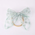 Détail du nœud en dentelle vert clair avec broderie de petites marguerites blanches - Vert clair