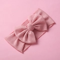 Dettaglio della fascia elastica in maglia a coste per neonati con un grande fiocco rosa - Rosa Profondo