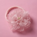 Detailed macro view of 3D layered chiffon flower with pearled center on nylon headband - Light Pink