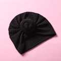 Detail der Waffelstruktur und des Knotens der schwarzen Strickmütze für Babys - Schwarz