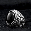 Macro detail of retro steel ring with black oval stone and side floral relief - US Size 7 / Black Agate