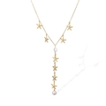 Elegant gold starfish Y-necklace with metallic charms and white pearl accents on white - Starfish