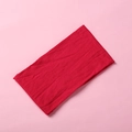 Detailed close-up of a vibrant red soft nylon baby headband on a light pink background - Dark Red