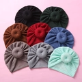 Flat lay of colorful waffle knit baby donut turbans in eight different vibrant shades - Random Style