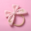 Detail of pink knitted bow headband with swan embroidery and soft nylon elastic band - Pink