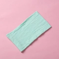 Macro detail of mint green soft nylon headband showing fine knit texture and elasticity - Emerald Green