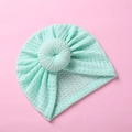 Detailed close-up of mint green waffle knit fabric and donut knot on infant turban hat - Emerald Green