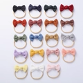 Flat lay display of 19 assorted colors of waffle texture baby bow headbands for infants - Random Mixed Colors