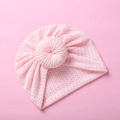 Detailed view of pink waffle knit baby hat with donut knot and breathable mesh texture - Pink