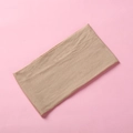 Detailed close-up of soft khaki nylon baby headband with elastic knitted texture - Nude