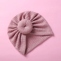 Close-up of baby waffle knit donut turban hat in dusty rose pink with textured fabric - Grape Purple