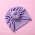 Detail of purple waffle knit baby donut turban hat with intricate hollow crochet texture - Purple