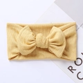 Close-up of mustard yellow ribbed knit baby headband with a large decorative bow - 17.5*7.5 cm / Earthy Yellow