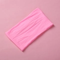 Detail shot of soft pink nylon headband featuring seamless ribbed knit texture for babies - Fluorescent Pink