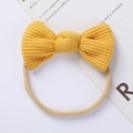 Detail of baby waffle bow headband in bright yellow with soft elastic nylon band - Yellow