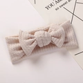 Detail showing soft waffle texture and oversized bow on this light pink baby headband - Khaki