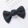 Close-up of dark grey waffle knit bow clip with textured fabric for kids hair - Waffle Texture Bow / Dark Gray