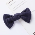Detailed macro view of navy blue waffle knit texture on a handmade bow hair clip - Waffle Texture Bow / Dark Blue