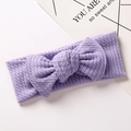 Detail of light purple knitted baby headband with a large bow on a white background - Purple