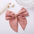 Detail of soft pink textured cotton hair bow with fine jacquard weave patterns - Deep Pink