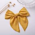 Detailed close-up of 6-inch ginger yellow jacquard fabric hair bow with textured finish - Ginger Yellow