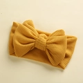 Close-up of bright yellow waffle knit texture and large bow detail on baby headband - 17*9 cm / Ginger Yellow