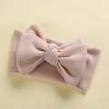 Close-up of baby headband with a large soft pink waffle knit bow texture and fabric detail - 17*9 cm / Beige
