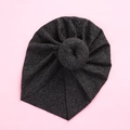 Detail of dark grey ribbed knit baby turban featuring a decorative donut knot on light pink background - Black