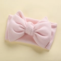 Detailed view of pink waffle texture baby headband with large handmade bow knot decoration - 17*9 cm / Pink