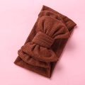 Detail of baby ribbed knit headband in rust orange with oversized double bow decoration - Brown