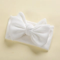 Close-up of white waffle knit elastic baby headband with a large double-layered bow - 17*9 cm / White