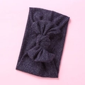 Detail of dark purple ribbed knit baby headband with a large elastic bow decoration - Navy Blue